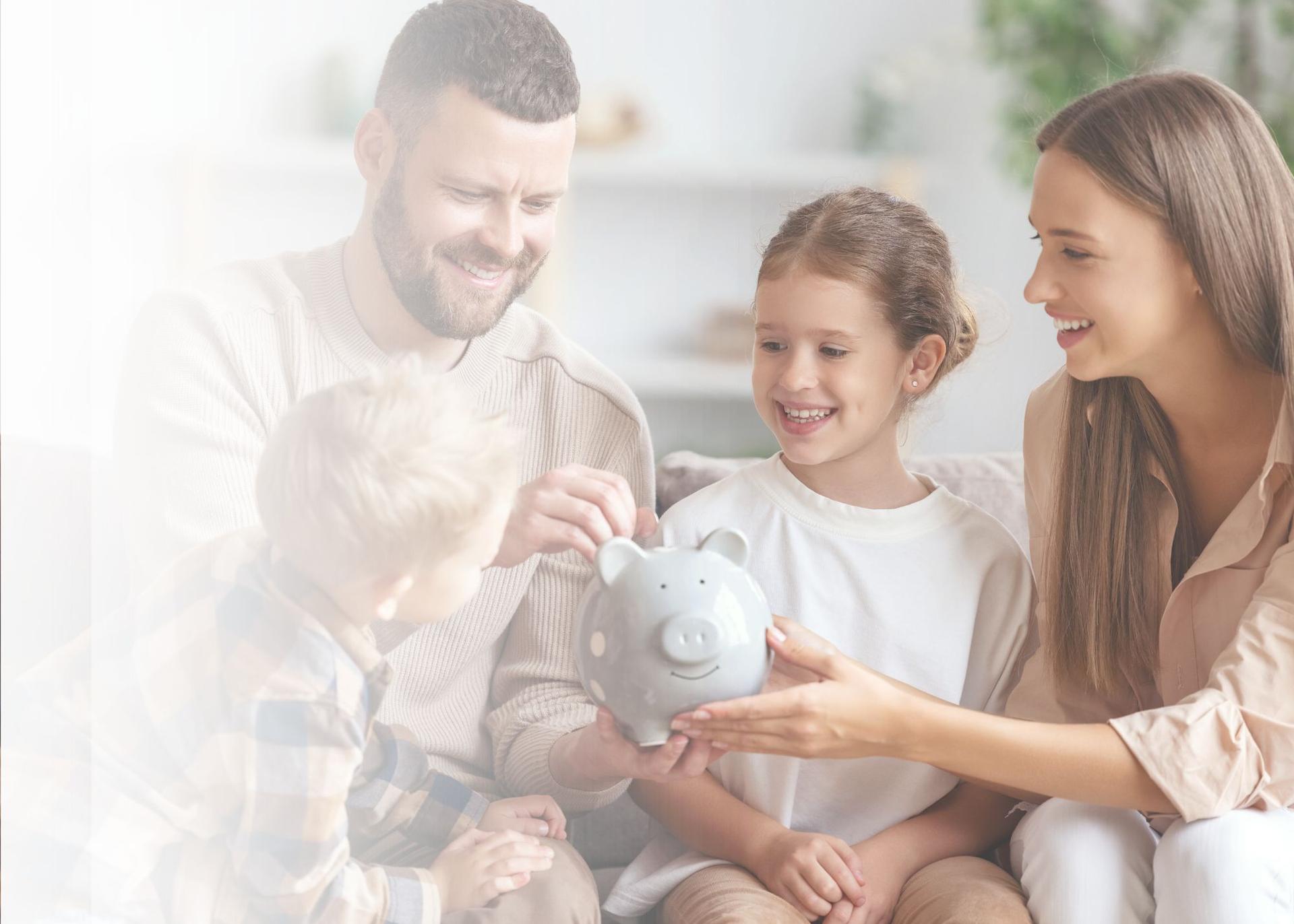 A family of four putting money into a piggy bank.
